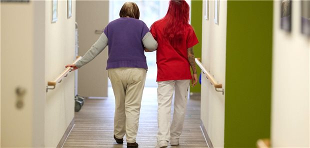 „Wir brauchen eine Lösung, die in den nächsten zwei Jahrzehnten trägt“ Eine Pflegekraft begleitet im DRK-Pflegezentrum Solferino eine Seniorin durch den Flur.