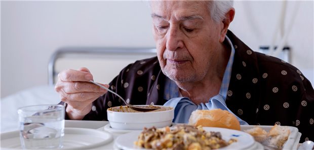 Ernährungs-Screening bei Menschen mit Krebs sollte Routine werden Ein Mann im Krankenhaus beim Essen.